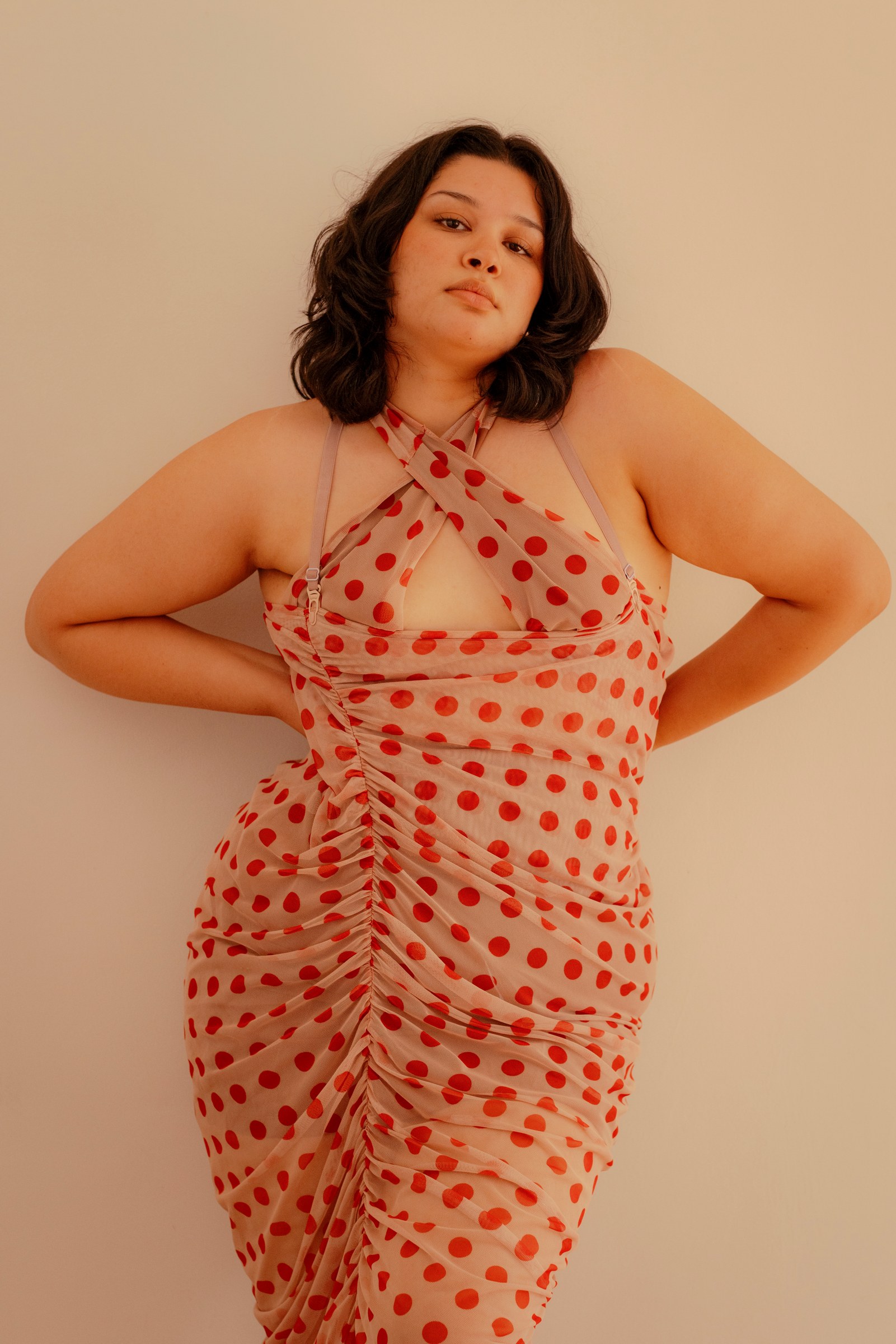 Woman standing confidently in a red patterned dress